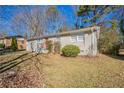 Gray ranch home with red door and mature trees at 454 Oak Se Dr, Atlanta, GA 30354
