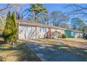 Front view of a charming ranch home with a concrete driveway at 454 Oak Se Dr, Atlanta, GA 30354