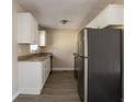 Renovated kitchen with granite counters, white cabinets, and stainless steel appliances at 454 Oak Se Dr, Atlanta, GA 30354