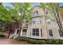 Tan three-story building with many windows and landscaping at 5641 Roswell Rd # 103, Atlanta, GA 30342