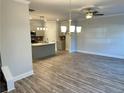 Open concept dining area with hardwood floors and modern light fixtures at 4131 Fulson Dr # 18, Lilburn, GA 30047