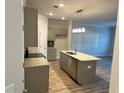 Modern kitchen with granite countertops, stainless steel appliances, and island at 4131 Fulson Dr # 18, Lilburn, GA 30047