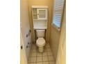 Bathroom with tiled floor, toilet, grab bars, and window at 143 Tracy Ln, Mcdonough, GA 30253