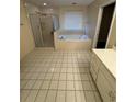 A bathroom features a shower, garden tub, and tile floor at 143 Tracy Ln, Mcdonough, GA 30253