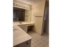 Bright bathroom with double sink vanity, tiled floor, and shower stall at 143 Tracy Ln, Mcdonough, GA 30253