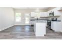 Modern kitchen with stainless steel appliances, granite countertops and open to a sunny room at 121 Hunters Ln, Powder Springs, GA 30127