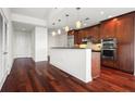 Modern kitchen with hardwood floors, stainless steel appliances, and dark wood cabinets at 270 17Th Nw St # 809, Atlanta, GA 30363