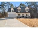 Two-story farmhouse with a white exterior, gray roof, and a large front porch at 56 Veranda Walk, Dallas, GA 30157
