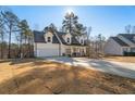 Two-story farmhouse with a white exterior, gray roof and a large front porch at 56 Veranda Walk, Dallas, GA 30157