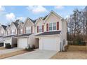Tan siding townhouses with red shutters and attached garages at 6977 Gallant Se Cir # 8, Mableton, GA 30126