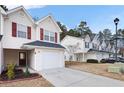 Townhouse with white siding, red shutters, and a two-car garage at 6977 Gallant Se Cir # 8, Mableton, GA 30126