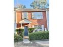 Brick two-story townhome with blue door, shutters, and manicured landscaping at 2884 Norfair Loop, Lithonia, GA 30038
