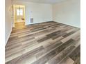 Spacious living room with wood-look vinyl flooring and view to dining area at 2884 Norfair Loop, Lithonia, GA 30038