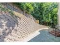 Landscaped backyard with retaining wall and fence providing privacy at 630 Darlington Commons Ne Ct, Atlanta, GA 30305