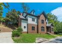 Side view of a charming two-story house with brick and white accents at 630 Darlington Commons Ne Ct, Atlanta, GA 30305
