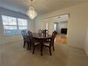 Formal dining room featuring a chandelier, a large window, and an elegant dining table at 665 Roxford Ln, Buford, GA 30518