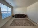 Cozy living room with neutral carpet, a sofa, rug, and large window with natural light at 665 Roxford Ln, Buford, GA 30518