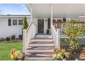 Inviting front porch with wooden steps and railing at 1207 Eastview Ne Rd, Conyers, GA 30012