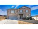 Two-story brick home with gray garage door and landscaping at 8484 Glenview St, Douglasville, GA 30134