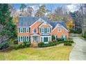 Two-story brick home with a landscaped yard at 3799 Halisport Nw Ln, Kennesaw, GA 30152