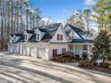 Expansive home with a four-car garage, mature landscaping and inviting front porch at 10 Moss Landing Se Rd, Acworth, GA 30102