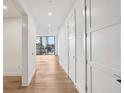 Bright hallway with hardwood floors and modern doors leading to other rooms at 2425 Peachtree Ne Rd # 701, Atlanta, GA 30305