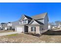 Two-story house with gray siding, brick accents, and a white door at 412 Vermeer Ct, Locust Grove, GA 30248