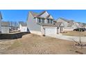 Two-story house with gray siding, brick accents, and a white door at 412 Vermeer Ct, Locust Grove, GA 30248