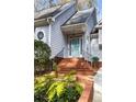 Inviting front porch with brick steps, wrought iron railings, and a charming blue front door at 1134 Ferncliff Ne Rd, Atlanta, GA 30324