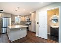 Modern kitchen with stainless steel appliances, gray cabinets, granite countertops, and hardwood floors at 4811 Warners Trl, Norcross, GA 30093