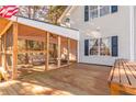 Spacious screened porch with wooden deck and seating at 2605 Poplar Ln, Cumming, GA 30041