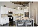 Modern kitchen with white cabinets, stainless steel appliances, and an island at 3235 Roswell Ne Rd # 718, Atlanta, GA 30305
