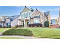 Two-story house with stone and siding accents, manicured lawn, and a welcoming front porch at 1060 Windy Elm Dr, Smyrna, GA 30082