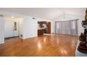 Open-concept living area features hardwood floors and a view into the kitchen at 1491 Stoneleigh Way, Stone Mountain, GA 30088