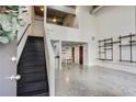 Open-concept living space with concrete floors, metal staircase, and view of the kitchen and dining area at 195 Arizona Ne Ave # 158, Atlanta, GA 30307