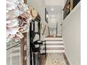 Bright and airy entryway with hardwood floors and coat rack at 279 Commons Ave, Woodstock, GA 30188