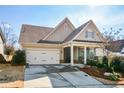 House exterior showcasing a two-car garage and neat landscaping at 314 Pepperwood Way, Canton, GA 30114