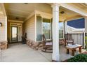 Inviting front porch with rocking chairs and stone accents at 314 Pepperwood Way, Canton, GA 30114