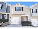 Townhouse exterior with a two-car garage and landscaping at 915 Highwood Ln, Atlanta, GA 30344