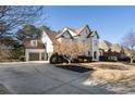 View of neutral painted brick home with 2-car garage and long driveway at 183 Applewood Ln, Acworth, GA 30101