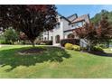 Landscaped home with manicured lawn, shrubbery, and brick and painted facade at 183 Applewood Ln, Acworth, GA 30101