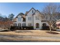 Charming two-story home featuring a manicured lawn and neutral painted brick exterior at 183 Applewood Ln, Acworth, GA 30101