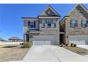 Charming townhome with a two-car garage, neutral brick, and manicured landscaping at 3353 Pearl Ridge Way, Buford, GA 30519