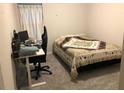 Cozy bedroom with carpeted floor, and a built-in workspace at 5602 Plain Field Ln, Lilburn, GA 30047