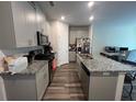Modern kitchen featuring gray cabinets and granite countertops at 5602 Plain Field Ln, Lilburn, GA 30047