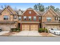 Brick front three-story townhome with two-car garage and landscaped yard at 262 Senna St, Marietta, GA 30064