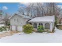 Gray house with a two-car garage and snowy front yard at 530 Balfour Dr, Decatur, GA 30032