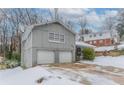 Gray house with a two-car garage and snowy front yard at 530 Balfour Dr, Decatur, GA 30032