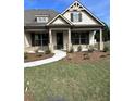 Front view of a house with stone accents and a covered porch at 1609 Tielman Way, Snellville, GA 30078