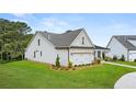 Beautiful two-story home with well-manicured lawn and attached garage, surrounded by mature trees at 3709 Tielman St, Snellville, GA 30078